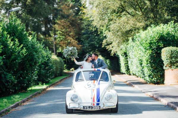 Bride and groom in wedding car convertible