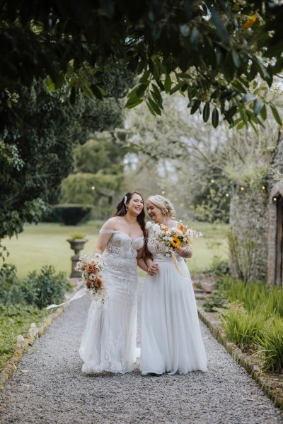 Brides wives close on path holding sunflowers bouquet garden