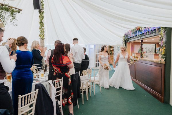 Brides wives guests holding hands