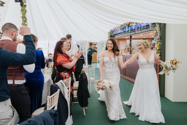 Brides wives guests holding hands