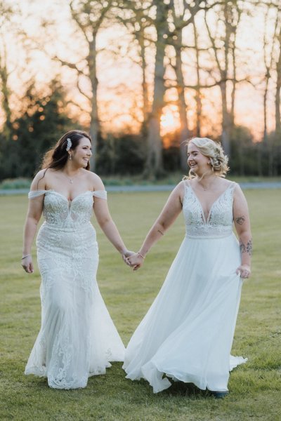 Brides hand in hand holding hands in field