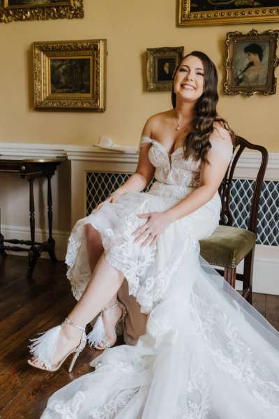 Bride laughs sitting on chair