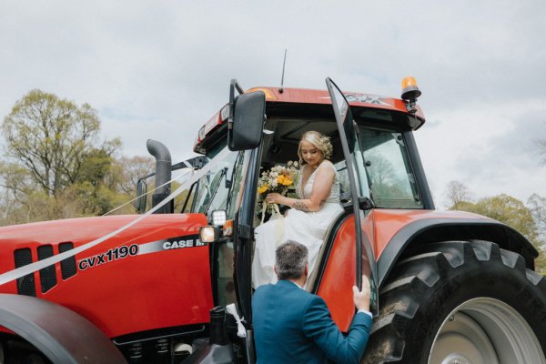 Bride gets into red tractor