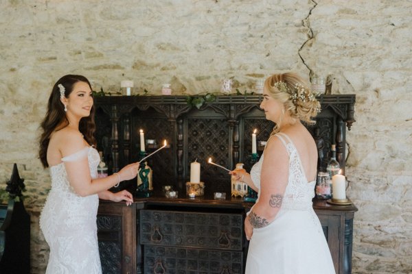 Brides lighting candles candlestick