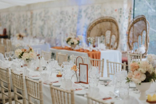 White tablecloth setting dining room flowers chairs