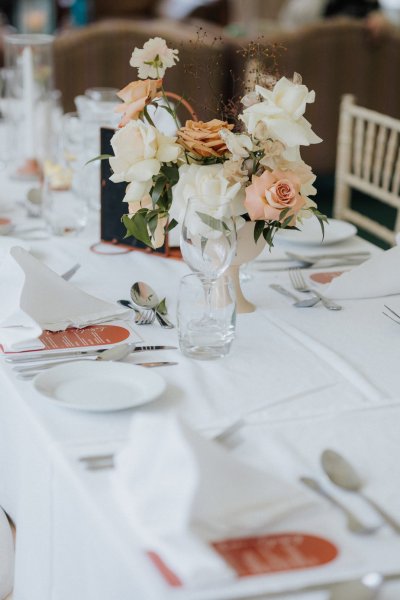 White tablecloth setting dining room flowers