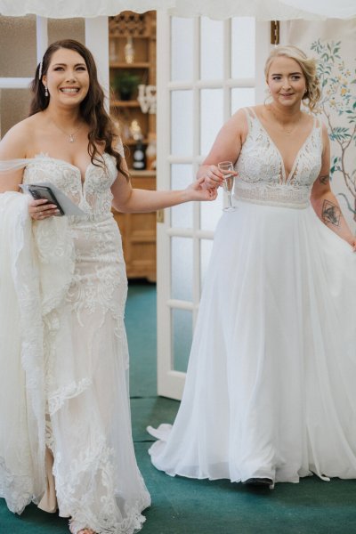 Brides in dining room together holding hands