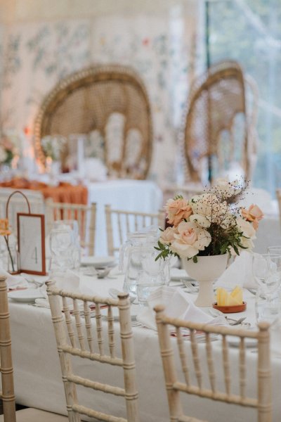 White tablecloth setting dining room flowers