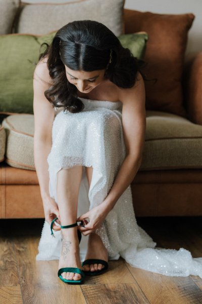 Bride putting on bridal heels shoes