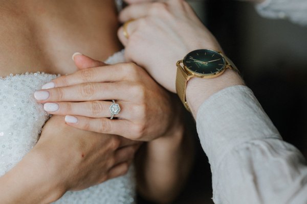 Close up of brides ring and grooms watch