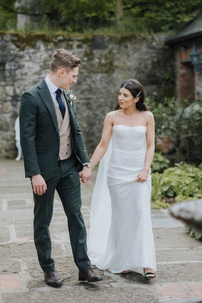 Bride and groom hand in hand venue