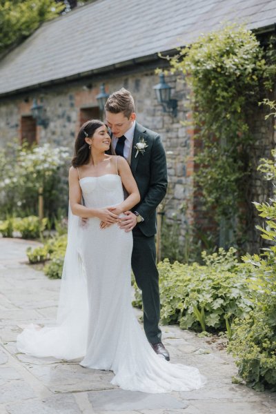 Bride and groom exterior forest park embrace