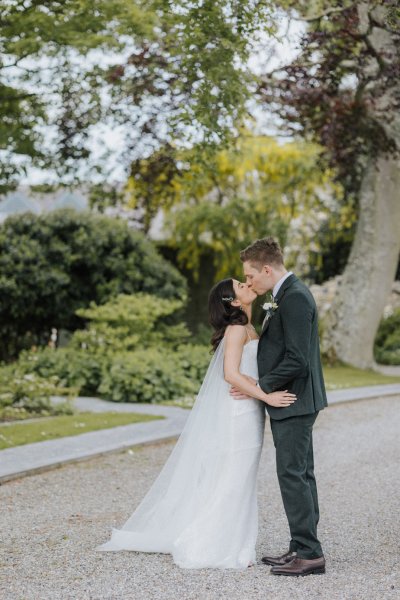 Bride and groom exterior forest park kiss kissing