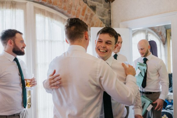 Groom and groomsmen hug