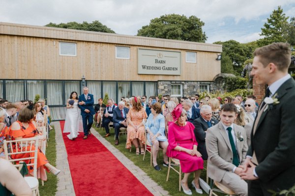 Father walks bride down the aisle guests