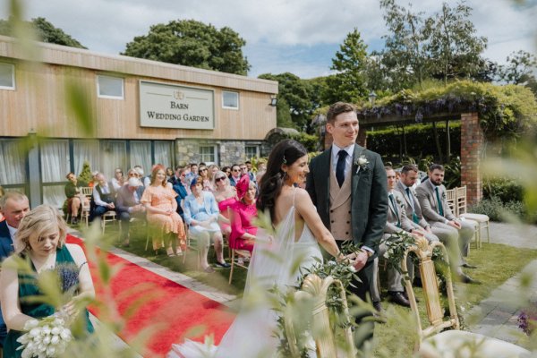 Bride groom and guests in background at wedding