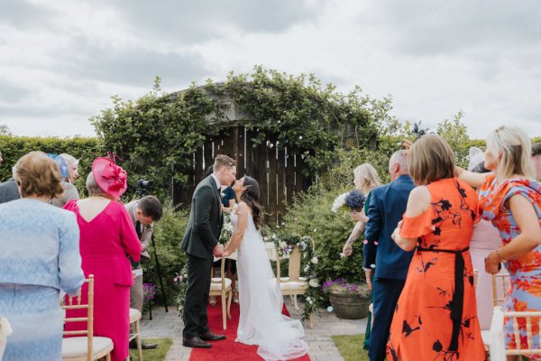 Couple pronounced bride and groom guests clapping