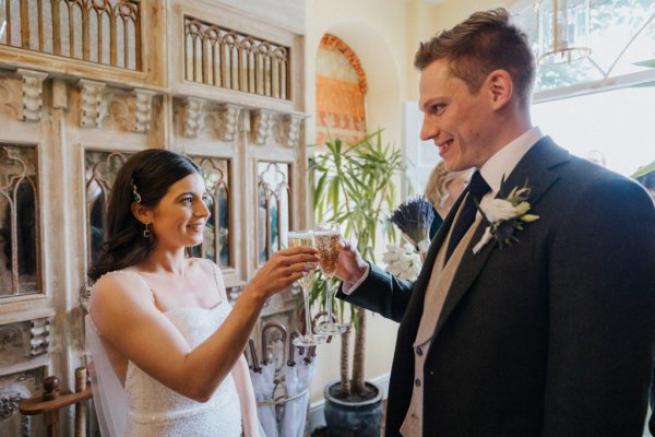 Bride and groom cheers champagne wine glasses