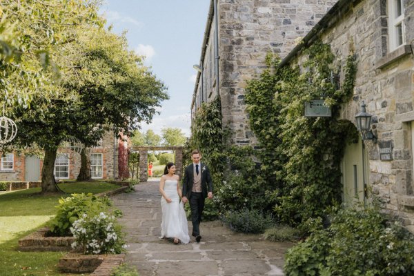 Couple bride and groom walk to venue