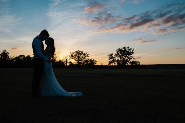 Nighttime shot of couple sunset hugging