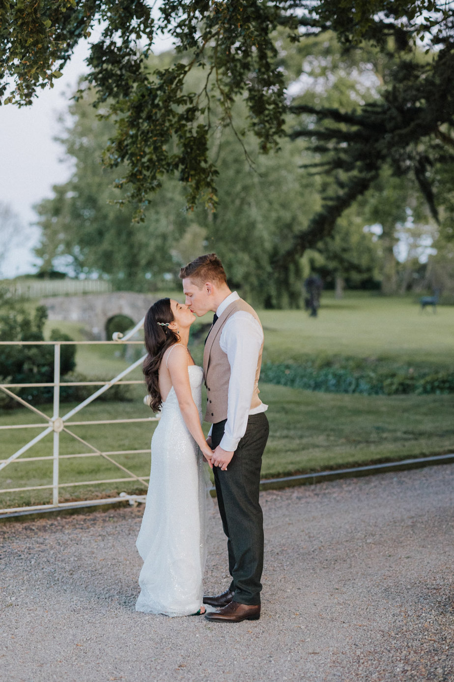 Bride and groom kiss farm park forest