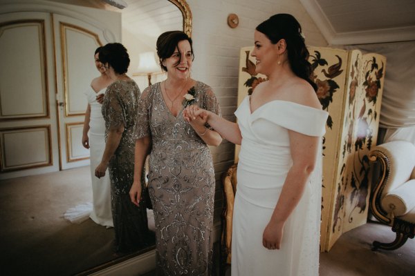 Mother and bride holding hands