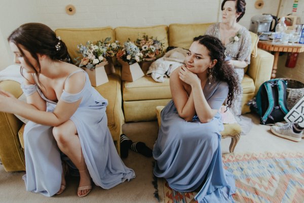 Bridesmaids sit and wait