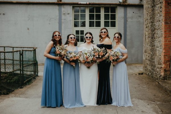 Bride wearing sunglasses with bridesmaids