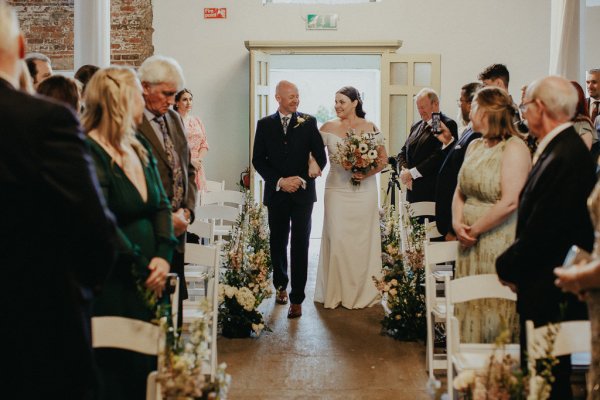 Father walks bride down the aisle guests