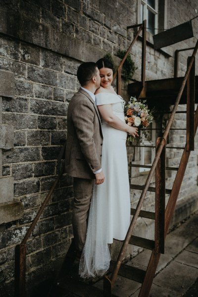 bride and groom on steps stairs