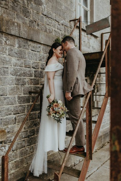 bride and groom on steps stairs