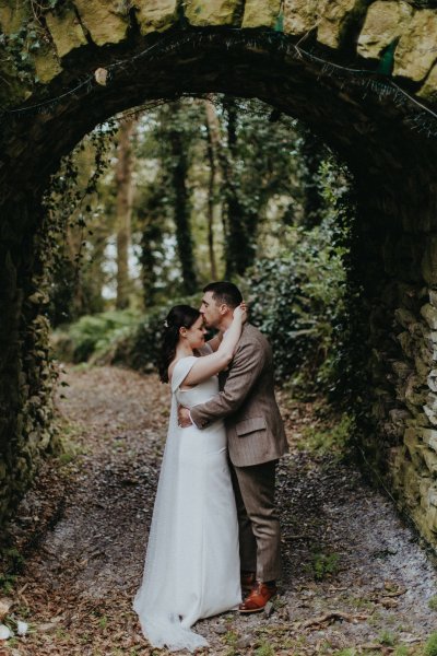 Bride and groom exterior forest park hideaway oval archway