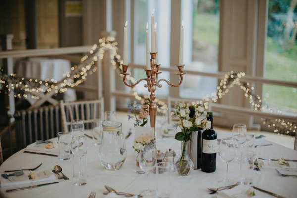 Dining room table with little bottles of wine and lights