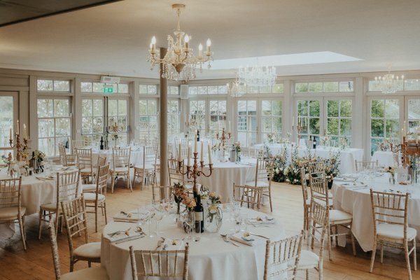 Dining room area flowers tables chandelier