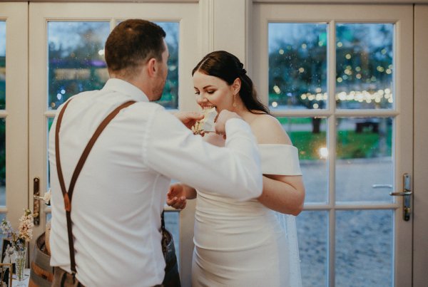 Bride and groom eating wedding cake