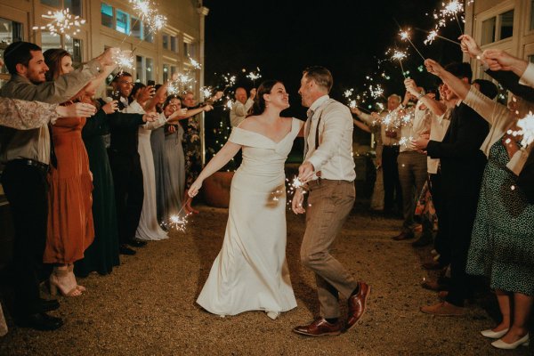 Dancefloor bride and groom marquee lights sparklers