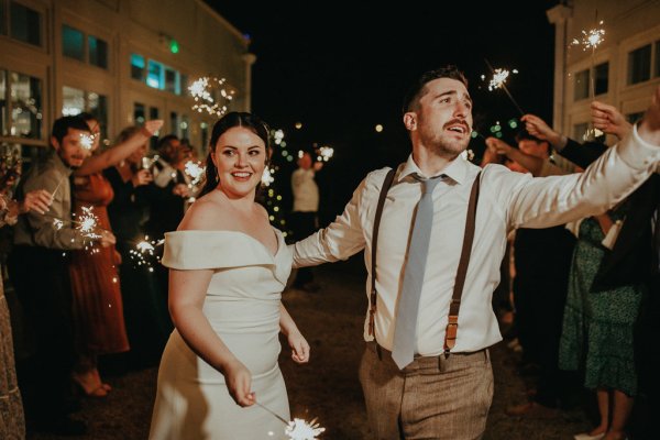 Dancefloor bride and groom marquee lights sparklers