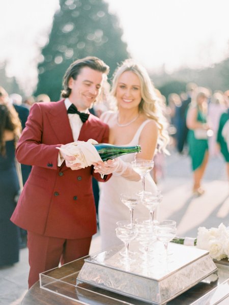 Bride and groom pouring champagne wine glasses