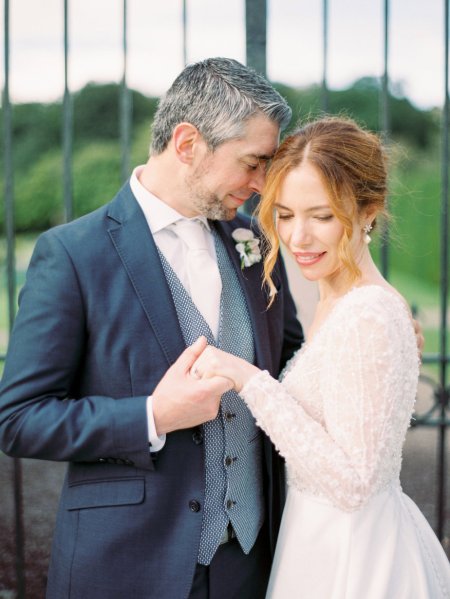 Bride and groom holding hands