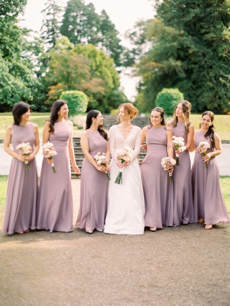 Bride and bridesmaids holding bouquet flowers