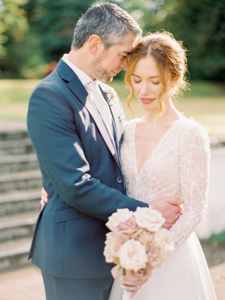 Bride holding Pink white roses flowers bouquet groom