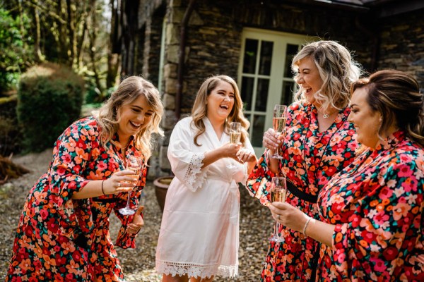 Bridesmaids red floral flowers holding flowers opening champagne prosecco