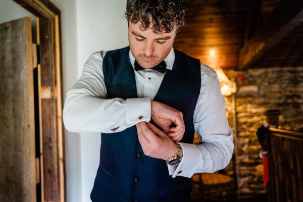 shot of groom getting ready bow and tie