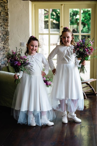 Flower girls holding bouquet of flowers