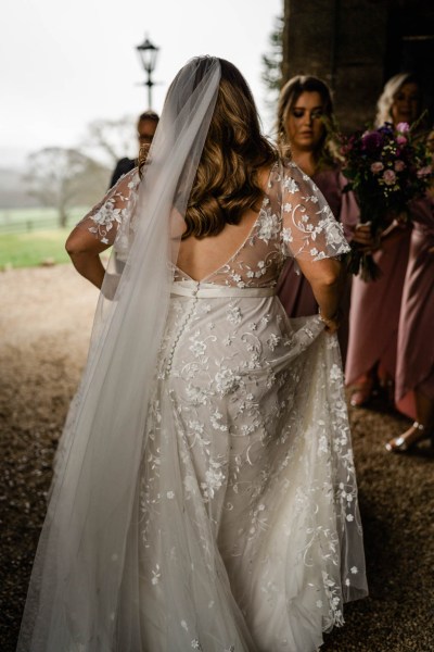 Bride from behind lifting up dress