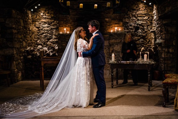 Bride and groom embrace hug at alter during ceremony