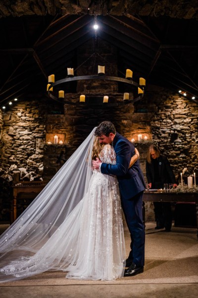 Bride and groom embrace hug at alter during ceremony