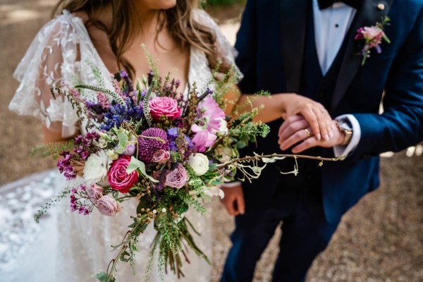 Bride and groom standing in park forest together