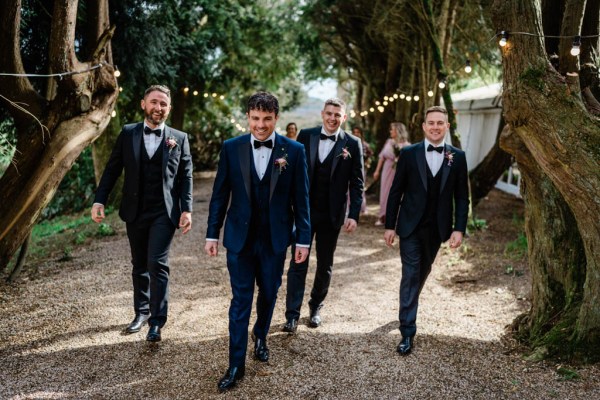 Groom and groomsmen walking outside