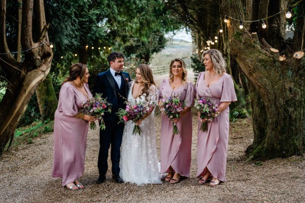 Bride bridesmaid and groom holding flowers bouquet